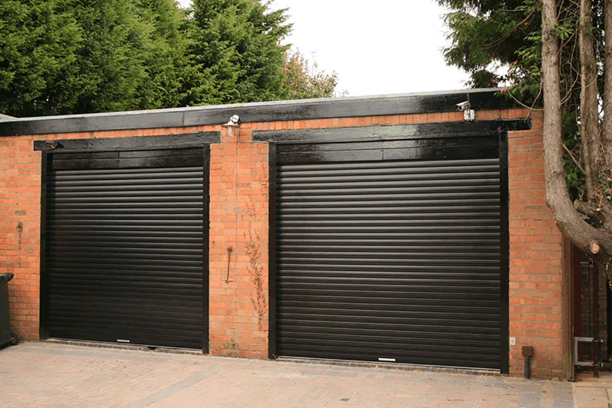 Two-Hi-Gloss-black-garage-doors-on-a-period-building